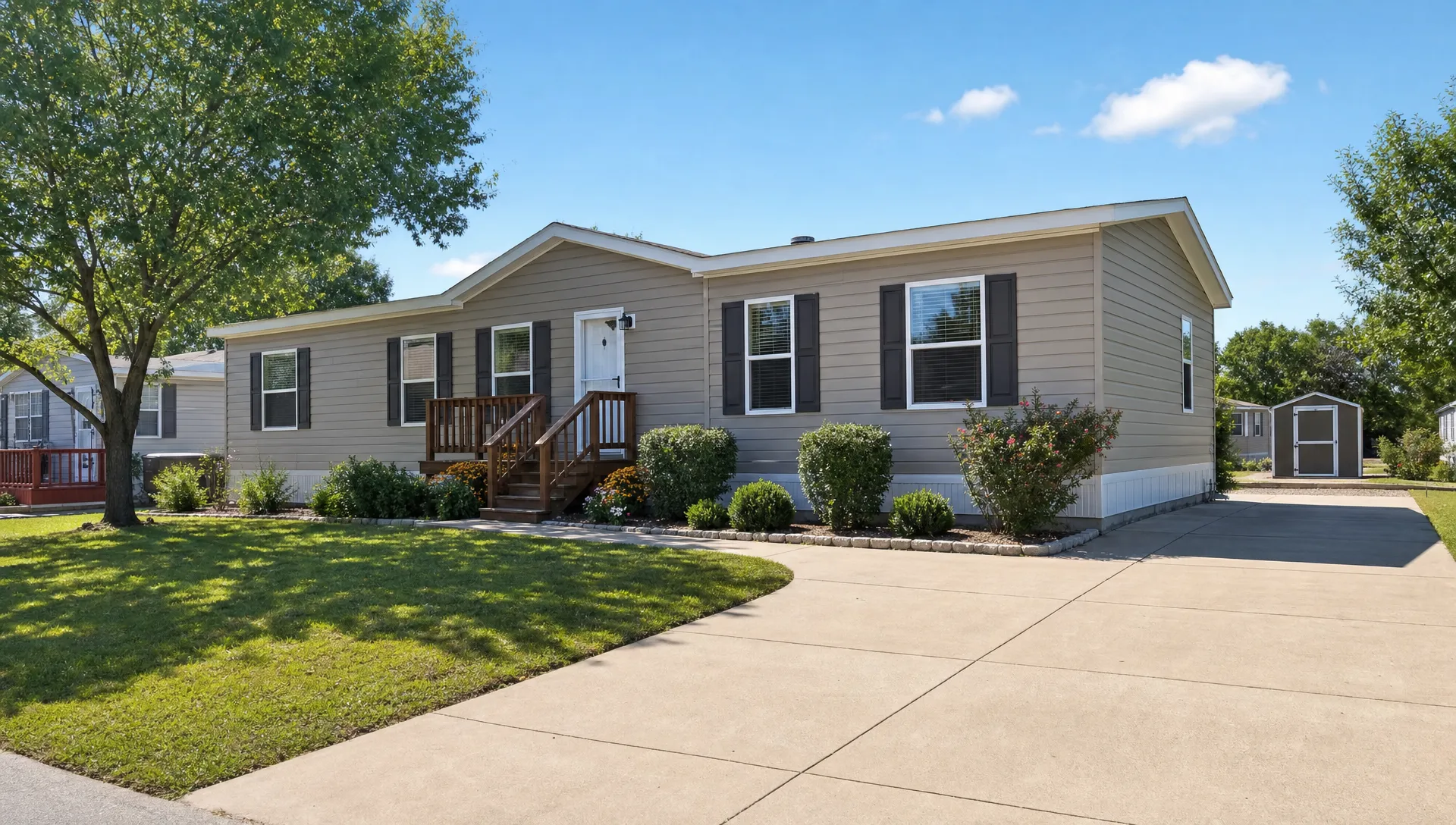 A single wide manufactured home sits on a clean lot with a small porch, trimmed landscaping and clear driveway access in a Texas neighborhood.