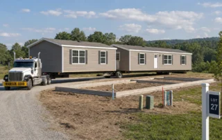 Two connected home sections above a foundation outline suggest double wide prefab home installation.