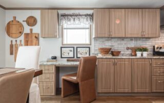 Kitchen cabinets with a built-in desk and a window over the counter