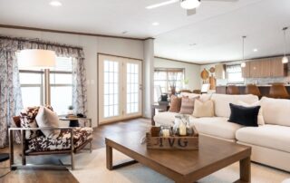 Living room with a sectional sofa, coffee table and windows on two sides