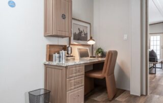 Built-in office nook with a desk and upper cabinets