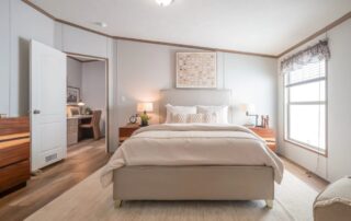 Primary bedroom with a queen bed and windows on two walls
