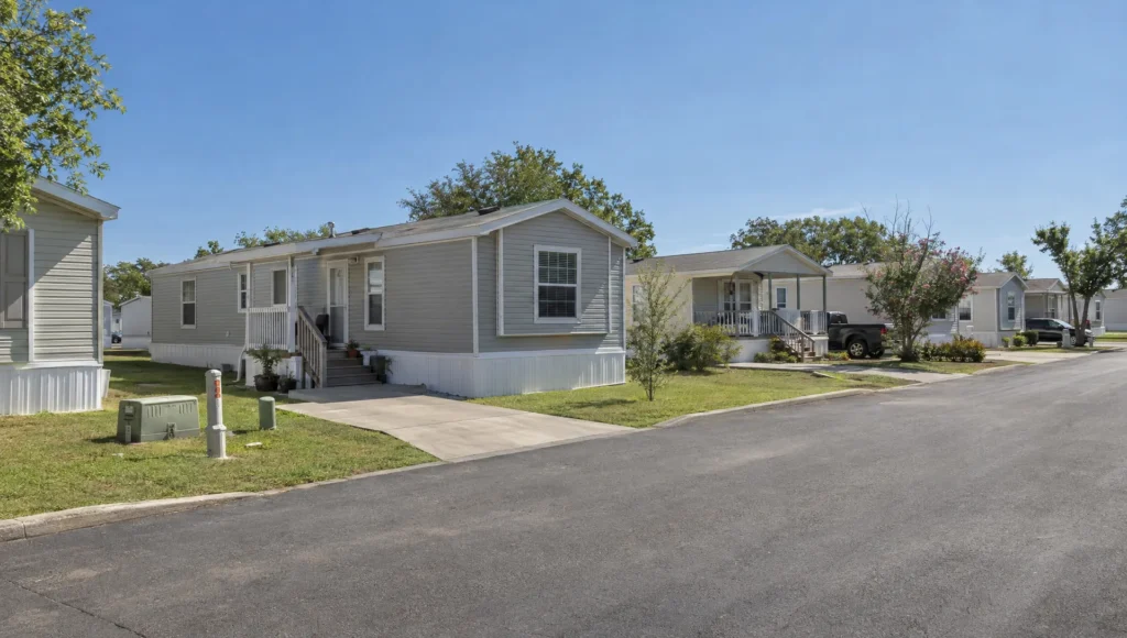 A pre-owned manufactured home sits among established community homes, where buyers can check the site and land arrangement for FHA eligibility.