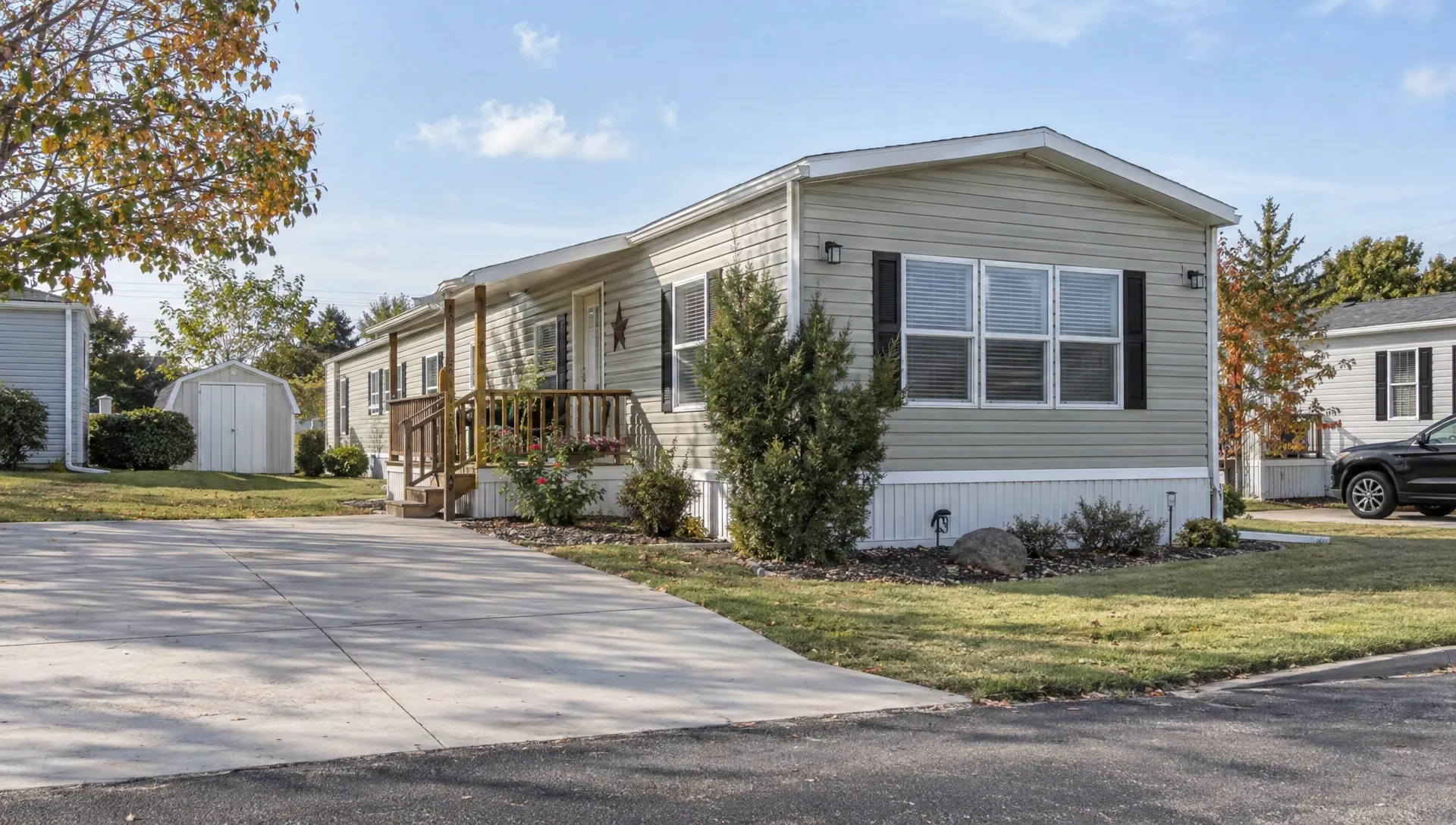 A well-maintained pre-owned manufactured home stands on its established homesite, with its yard, driveway, and neighboring houses visible as buyers assess the property for FHA financing.